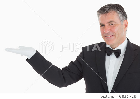 Smiling waiter showing us his opened hand Smiling waiter showing us his opened hand 6835729