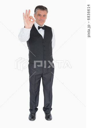 Smiling waiter showing ok sign 6836614
