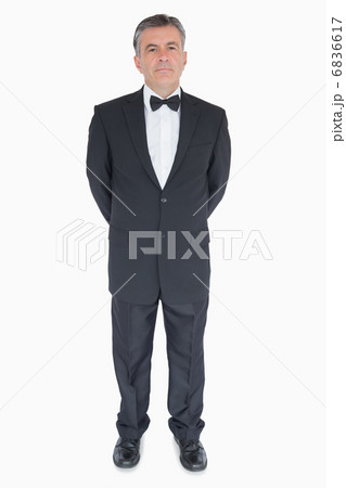 Man standing with hands behind his back Man standing with hands behind his back 6836617