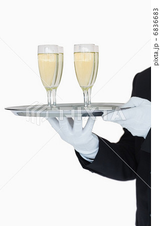 Waiter holding tray of champagne flutes Waiter holding tray of champagne flutes 6836683