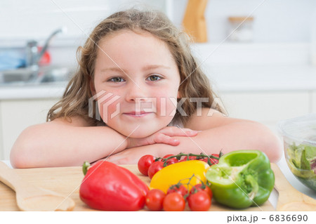 Girl leaning beside vegetables 6836690