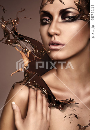 close up portrait of attractive woman with chocolate splash close up portrait of attractive woman with chocolate splash 6872115