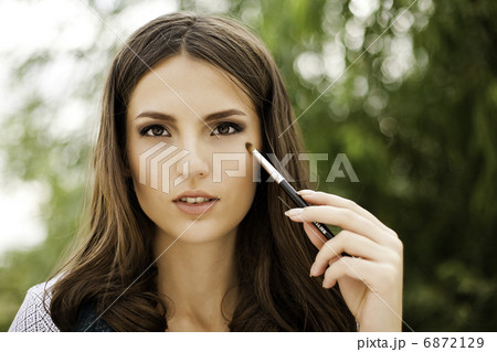 portrait of beautiful brunette girl making up 6872129