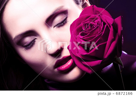 close-up portrait of beautiful woman with rose 6872166