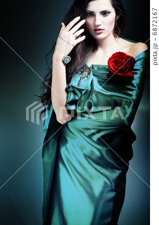 beautiful woman in green fabric with red rose 6872167