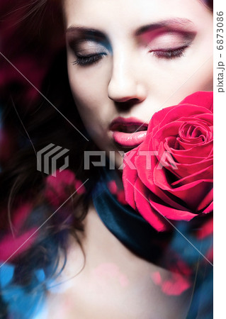 beautiful woman with red rose and blue lights beautiful woman with red rose and blue lights 6873086