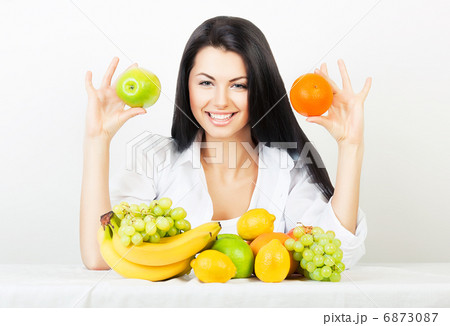 smiling woman with apple and orange in hands smiling woman with apple and orange in hands 6873087