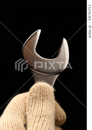 Metallic wrench in male hand Metallic wrench in male hand 6876451