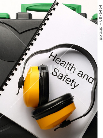 Black toolbox with earphones on white background Black toolbox with earphones on white background 6876464
