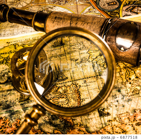 Vintage magnifying glass lies on an ancient world map Vintage magnifying glass lies on an ancient world map 6877518
