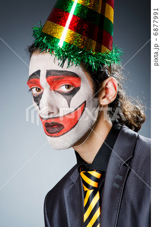 Businessman with clown wig and face paint Businessman with clown wig and face paint 6877991