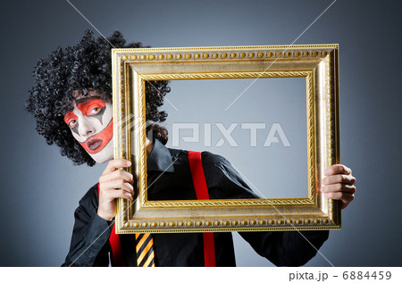 Clown with picture frames in studio Clown with picture frames in studio 6884459