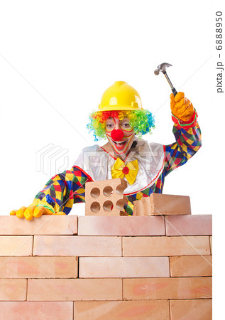 Bad construction concept with clown laying bricks Bad construction concept with clown laying bricks 6888950