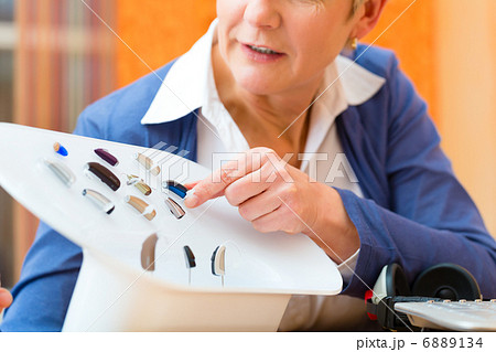 Deaf woman with hearing aid 6889134