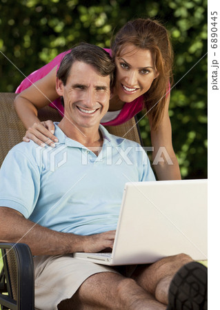 Happy Middle Aged Man and Woman Couple Using Laptop Computer 6890445