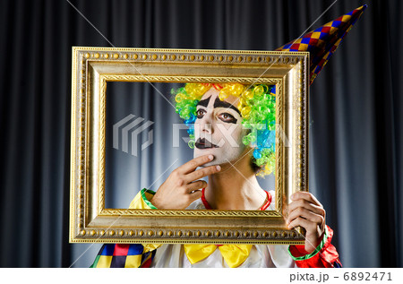 Clown with picture frames in studio Clown with picture frames in studio 6892471