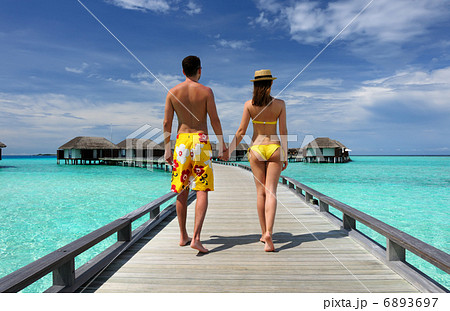 Couple on a beach jetty at Maldives 6893697