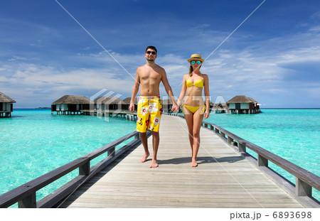 Couple on a beach jetty at Maldives 6893698
