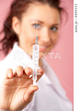 Female doctor hand holding syringe 6894353