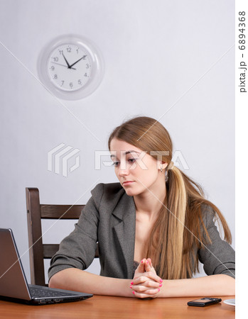 Serious businesswoman working on laptop 6894368