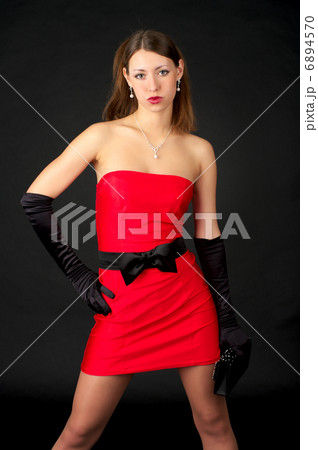 Beautiful young woman in short red dress Beautiful young woman in short red dress 6894570