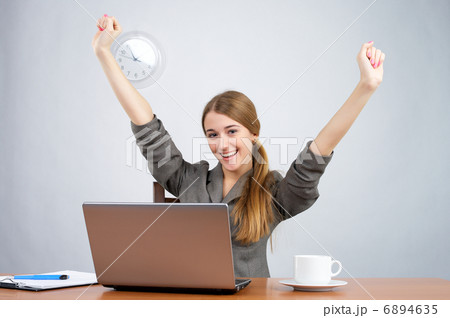 Businesswoman at desk with arms thrown up Businesswoman at desk with arms thrown up 6894635