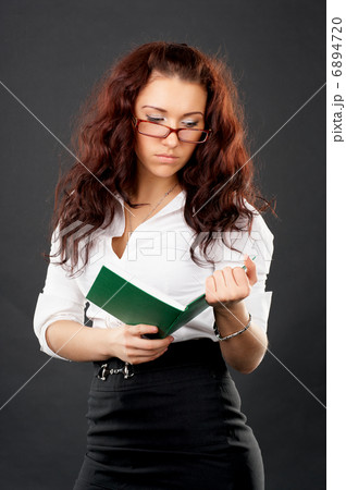 Young university girl reading book 6894720