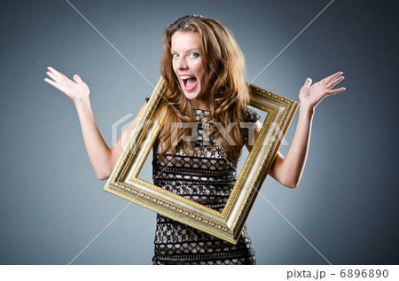 Young woman with picture frame on white Young woman with picture frame on white 6896890