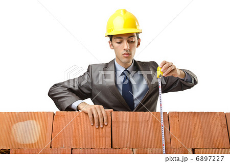 Businessman with bricks on white 6897227