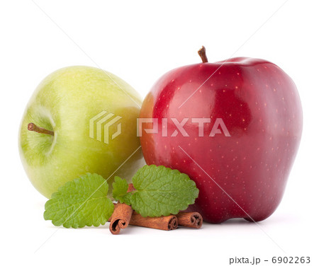 Red and green apples, cinnamon sticks and mint leaves still life 6902263