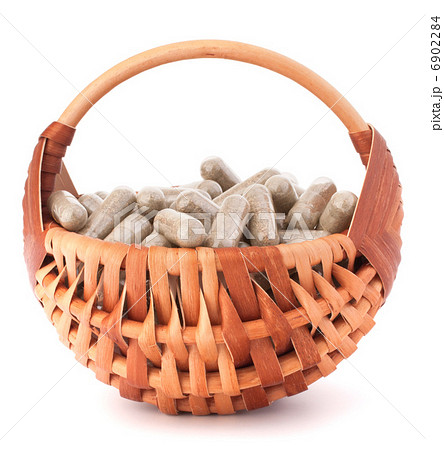 Herbal drug capsules in wicker basket. Alternative medicine conc Herbal drug capsules in wicker basket. Alternative medicine conc 6902284