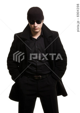 confidence man in black coat and sunglasses 6904398