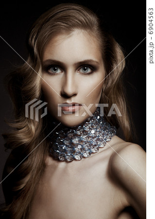 Beautiful woman with evening make-up. Jewelry and Beauty. Fashio 6904563