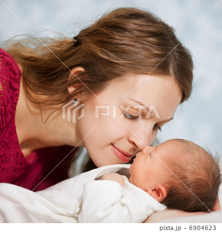 picture of happy mother with baby in bedroom picture of happy mother with baby in bedroom 6904623