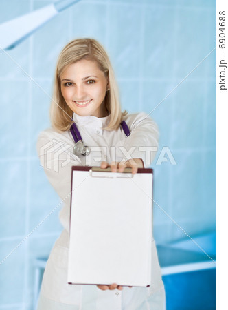 Smiling young female medical doctor with stethoscope and clipboa Smiling young female medical doctor with stethoscope and clipboa 6904688