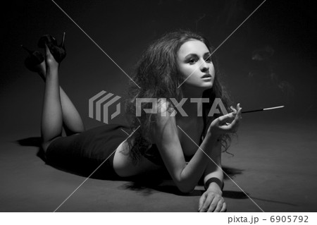 woman smokes in the dark. studio shot. BW Image woman smokes in the dark. studio shot. BW Image 6905792