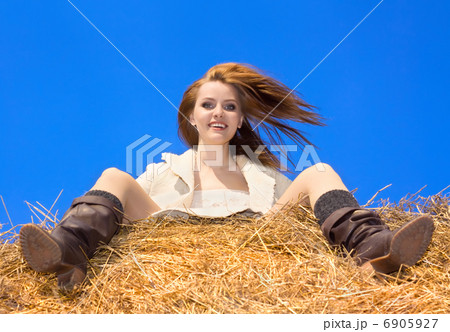 beautiful happy woman siting on haystack under blue heaven beautiful happy woman siting on haystack under blue heaven 6905927
