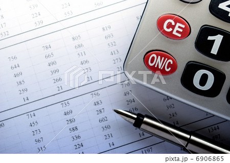 calculator and stationery items on the table 6906865