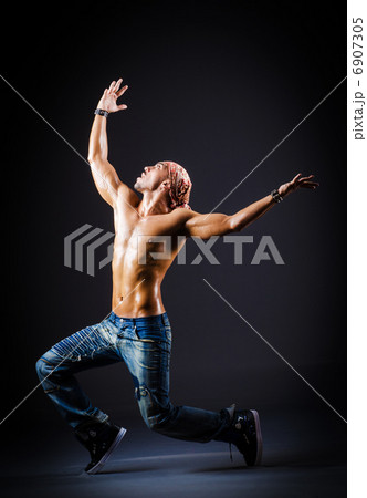 Dancer dancing in dark room Dancer dancing in dark room 6907305