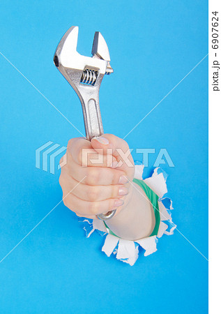 Hand holding chrome wrenh Hand holding chrome wrenh 6907624