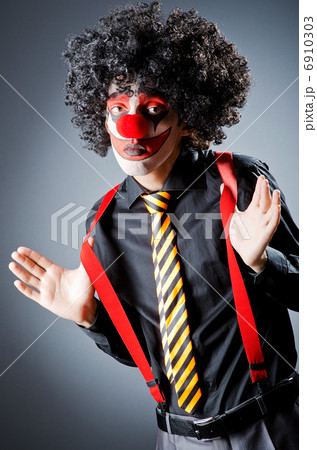 Businessman with clown wig and face paint Businessman with clown wig and face paint 6910303