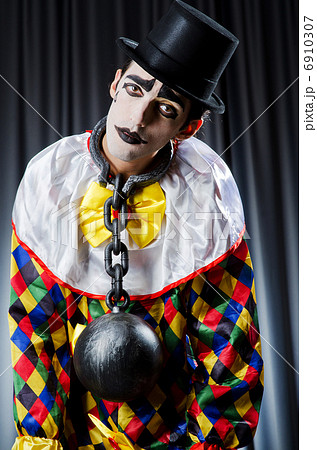 Clown with shackles in studio 6910307