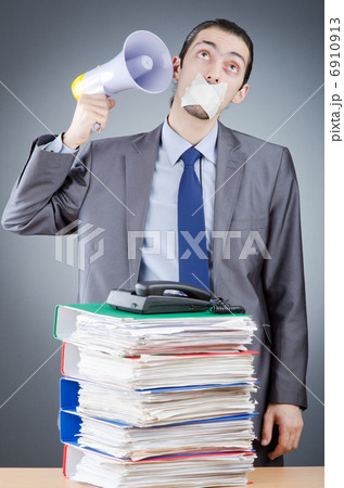 Businessman shouting via loudspeaker Businessman shouting via loudspeaker 6910913