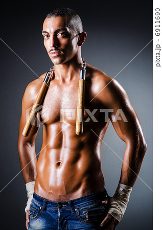 Strong man with nunchaku Strong man with nunchaku 6911690