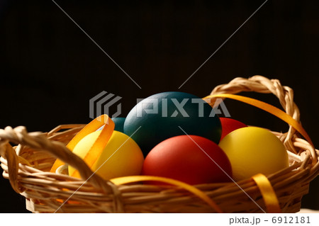 Easter eggs with yellow ribbon in basket 6912181
