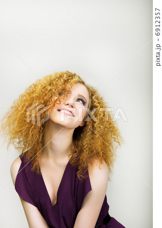 Lifestyle. Radiant Happy Woman with Curly Golden Hairs smiling. Positive Emotions Lifestyle. Radiant Happy Woman with Curly Golden Hairs smiling. Positive Emotions 6912357