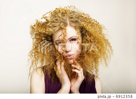 Embarrassment. Shaggy Red-Haired Curly woman grimacing. Play the Ape 6912358