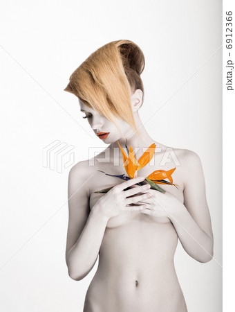 White Body Art. Daydreaming Naked Woman holding Fresh Flower. Exotic Hairstyle 6912366