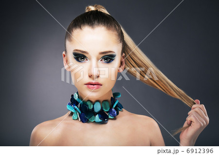 Treatment. Woman holding Tips of her long faint Hair in hand 6912396