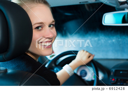 Young woman drives car in wash station Young woman drives car in wash station 6912428